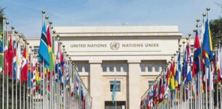 United Nations building with rows of world flags