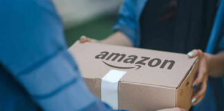 Two people exchanging an Amazon package, outdoors.