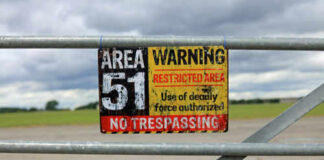 Area 51 warning sign on metal fence