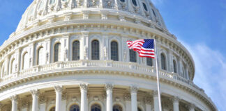 US Capitol dome with American flag flying