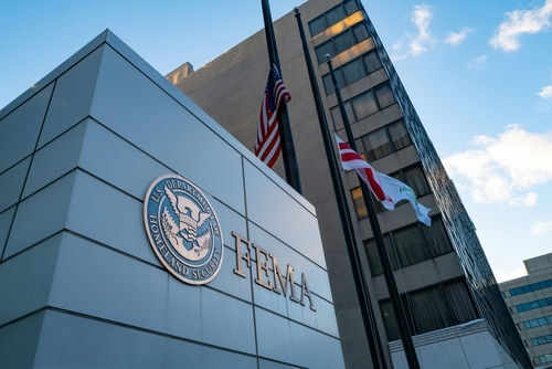 fema2576994047 FEMA building with flags outside and blue sky