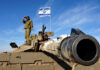 Beaufort Grab Sparks ‘New Gaza’ Fears Soldier saluting from atop a tank with an Israeli flag in the background