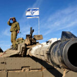 Beaufort Grab Sparks ‘New Gaza’ Fears Soldier saluting from atop a tank with an Israeli flag in the background
