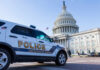 Police vehicle parked in front of the Capitol building