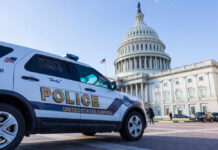 Police vehicle parked in front of the Capitol building