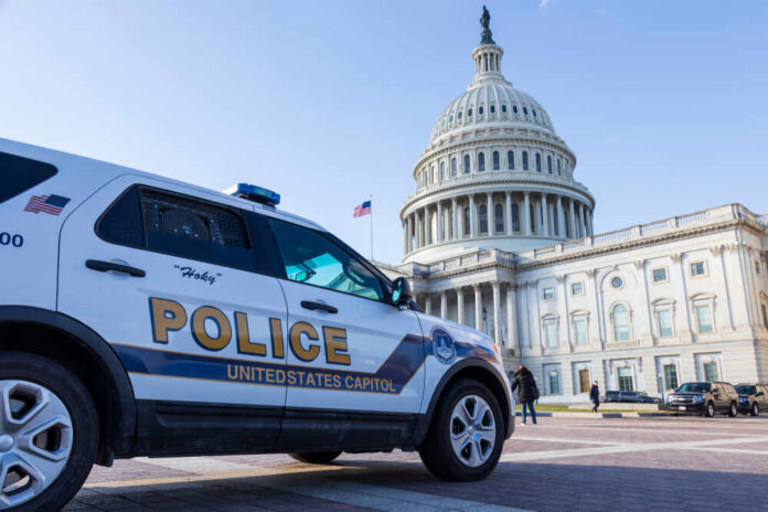 Police vehicle parked in front of the Capitol building