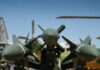 Tel Aviv Blasts Live — What’s Real? Close-up view of military missiles with aircraft in the background