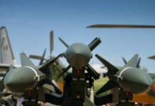 Tel Aviv Blasts Live — What’s Real? Close-up view of military missiles with aircraft in the background