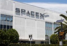 Blue-Collar Bonanza At SpaceX Exterior view of the SpaceX headquarters building with a speed limit sign