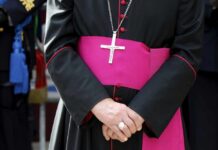 Grim Pattern: Bishop Shot, Answers Missing A religious figure in ceremonial attire with a cross necklace