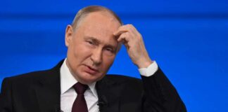 A political leader appearing thoughtful during a press conference