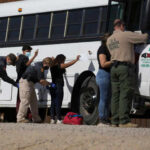People being searched by border patrol officers