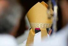Bishop wearing a golden mitre during a ceremony