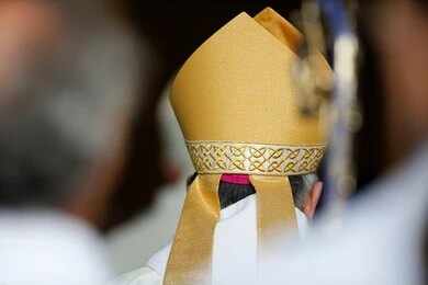 Bishop wearing a golden mitre during a ceremony