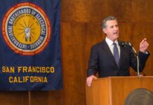 Newsom’s Next Move Has Conservatives Watching Man in suit giving a speech at a podium