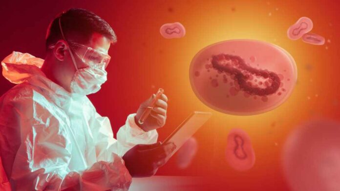 A scientist in protective gear examining monkeypox bacteria in a laboratory setting