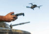 Ukraine’s Missile Runs On Drone Software Hands holding a drone controller with quadcopter in flight