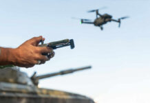 Ukraine’s Missile Runs On Drone Software Hands holding a drone controller with quadcopter in flight