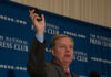 Man holding phone at National Press Club event