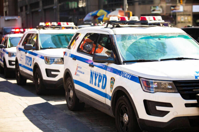 republicaninformer3jpg Parked row of NYPD police vehicles with flashing lights.