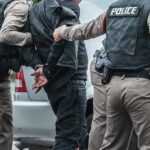 The Viral ICE Story Faces A Reality Check Police officers arresting a person beside a car