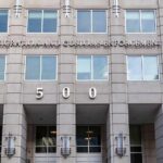 US government building facade with flags and number 500