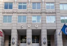 Deadly Raids, Explosive Panel Meltdown US government building facade with flags and number 500