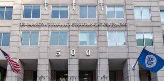 US government building facade with flags and number 500