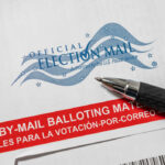Mail-in ballot envelope with pen
