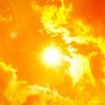 Sun shining through bright orange clouds