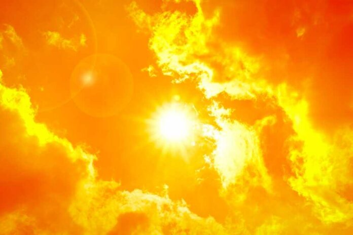 Sun shining through bright orange clouds