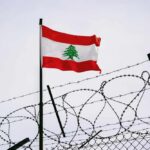 Trump’s Lebanon Deal Meets Early Opposition Lebanese flag waving next to barbed wire fence