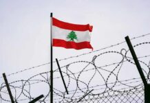 Trump’s Lebanon Deal Meets Early Opposition Lebanese flag waving next to barbed wire fence