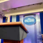 Empty podium in White House press briefing room.