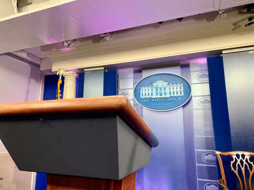 Empty podium in White House press briefing room.