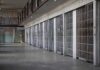 A Mass, A Mob, And 104 Days Jailed prison cell block with metal barred doors