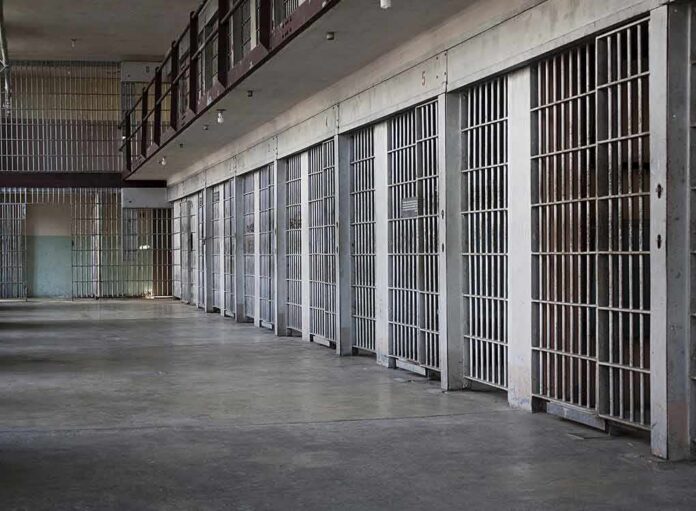prison cell block with metal barred doors