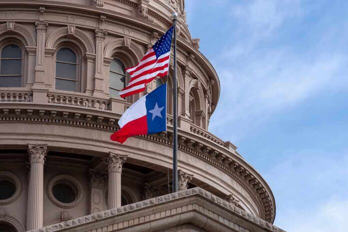 Texas and U.S. flags in front of a capitol building dome