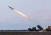 Cruise missile launches from mobile launcher in open field