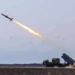 Cruise missile launches from mobile launcher in open field