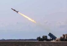 Cruise missile launches from mobile launcher in open field