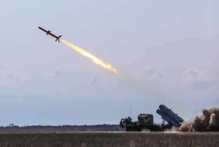 Cruise missile launches from mobile launcher in open field