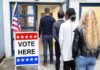 Voters standing in line at a polling place entrance