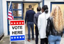 Voters standing in line at a polling place entrance