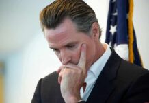 When “Anti-Doxxing” Starts Raising Speech Questions man in suit touching his face thoughtfully