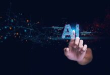 Trump’s AI Play Walks A Careful Line Hand touching glowing AI text with digital network nodes