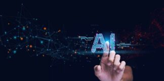 Hand touching glowing AI text with digital network nodes