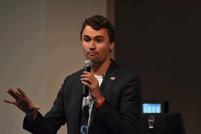man speaking into a microphone on stage