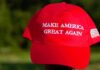 Red baseball cap with political slogan and small U.S. flag patch