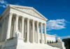 Supreme Court building with marble columns under blue sky